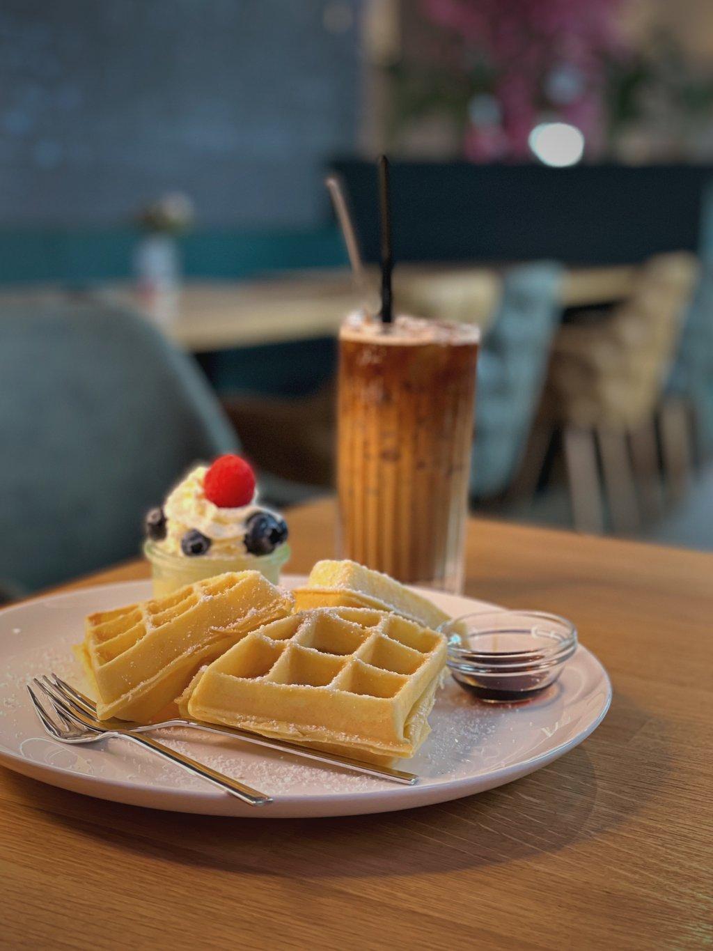Hausgemachte Waffeln mit Beeren und vietnamesischem Eiskaffee